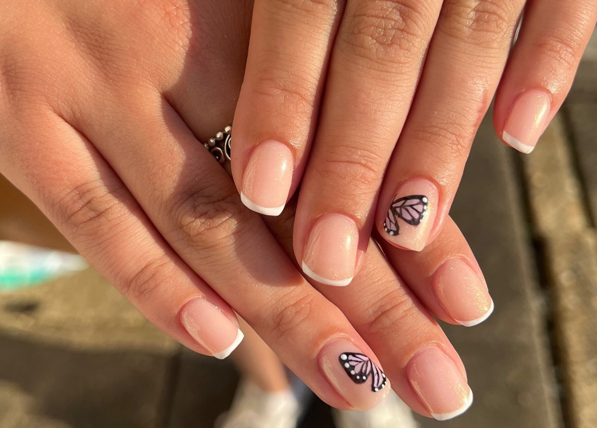 Elegant French manicure with butterfly design at By Bethany Rose, Hatfield, England, GB.