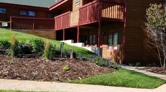Entrance view of Natural Reflections Spa in Elizabeth, Colorado, US with lush landscaping.