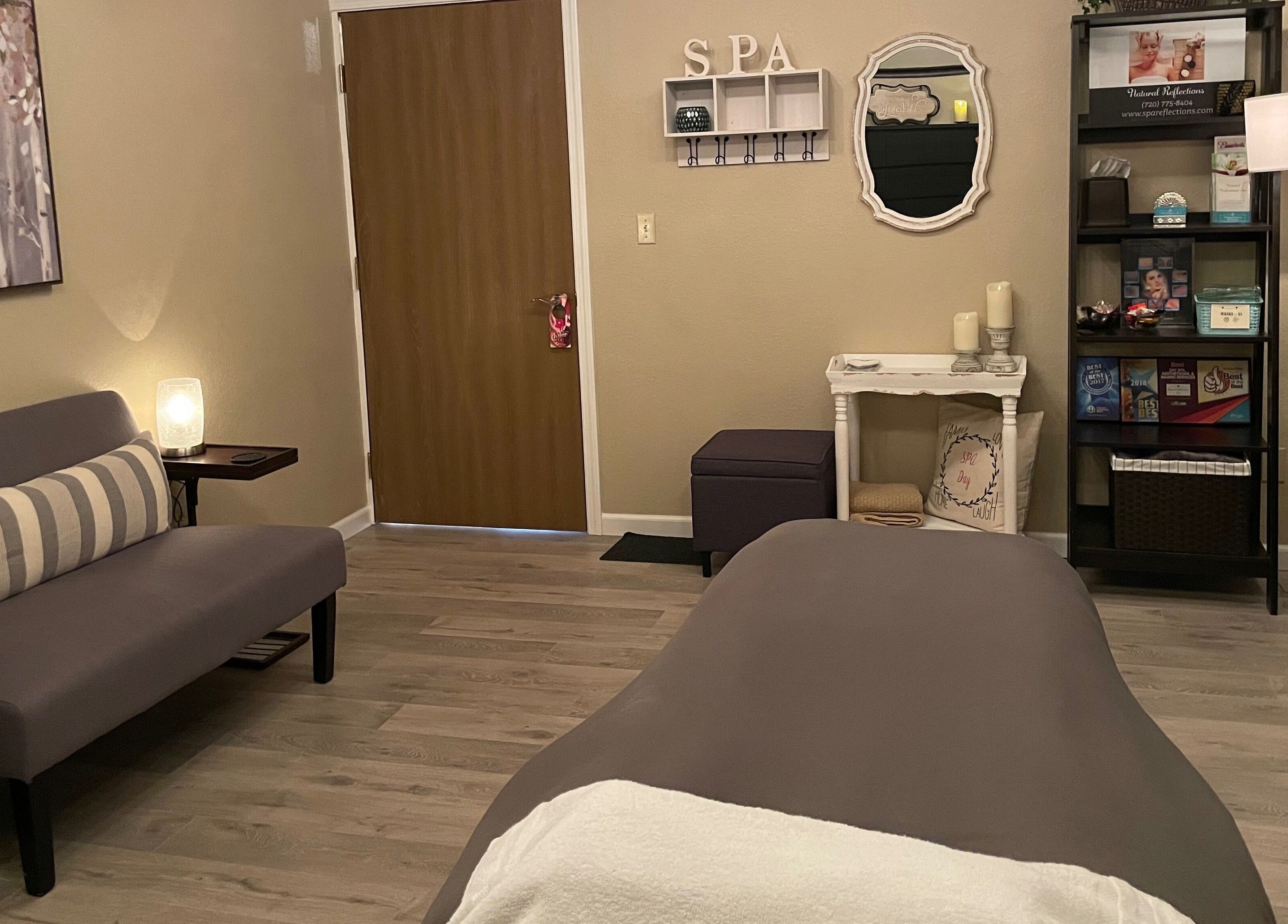 Relaxing treatment room at Natural Reflections Spa, Elizabeth, Colorado, US with cozy decor and soothing ambiance.