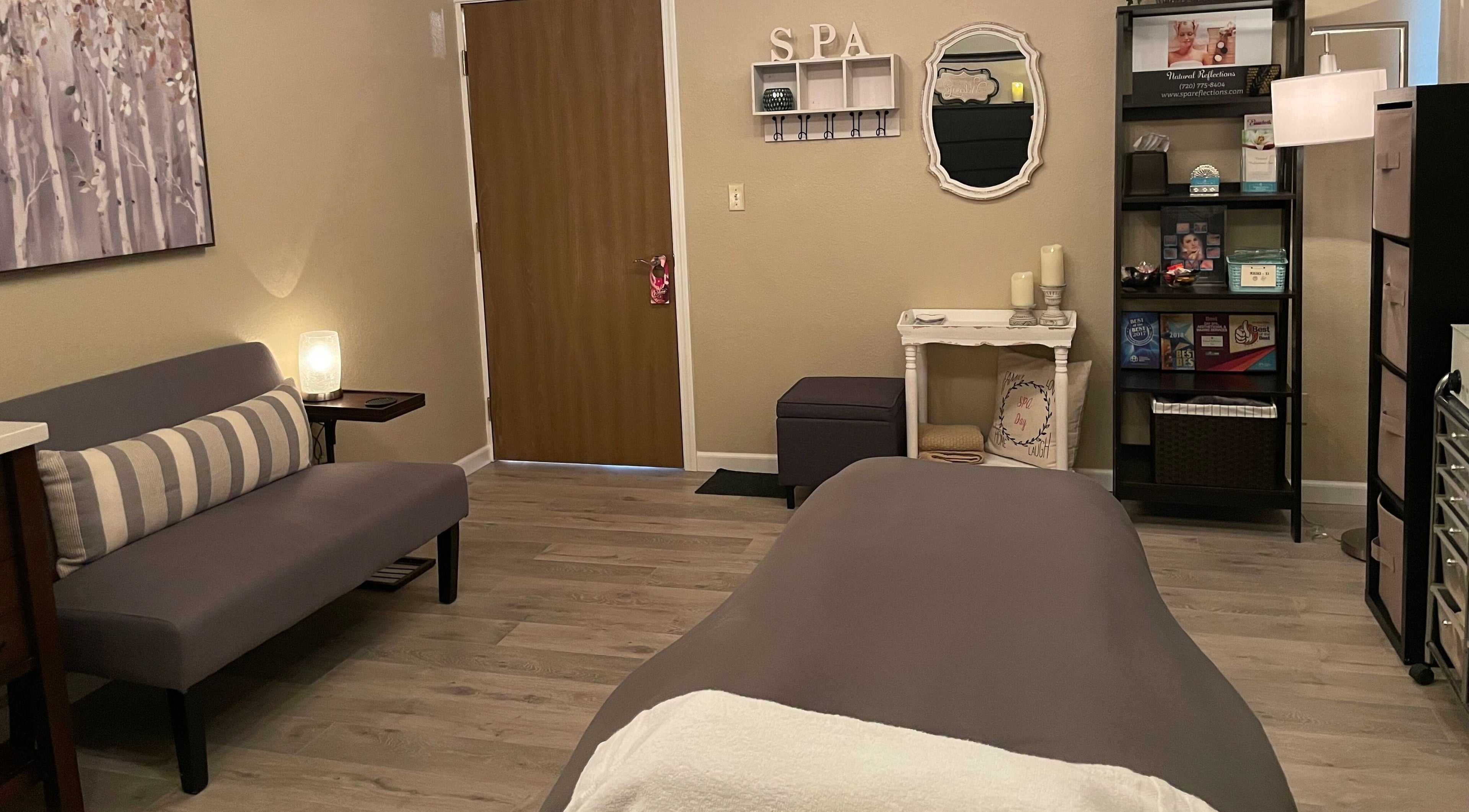 Relaxing treatment room at Natural Reflections Spa, Elizabeth, Colorado, US with cozy decor and soothing ambiance.