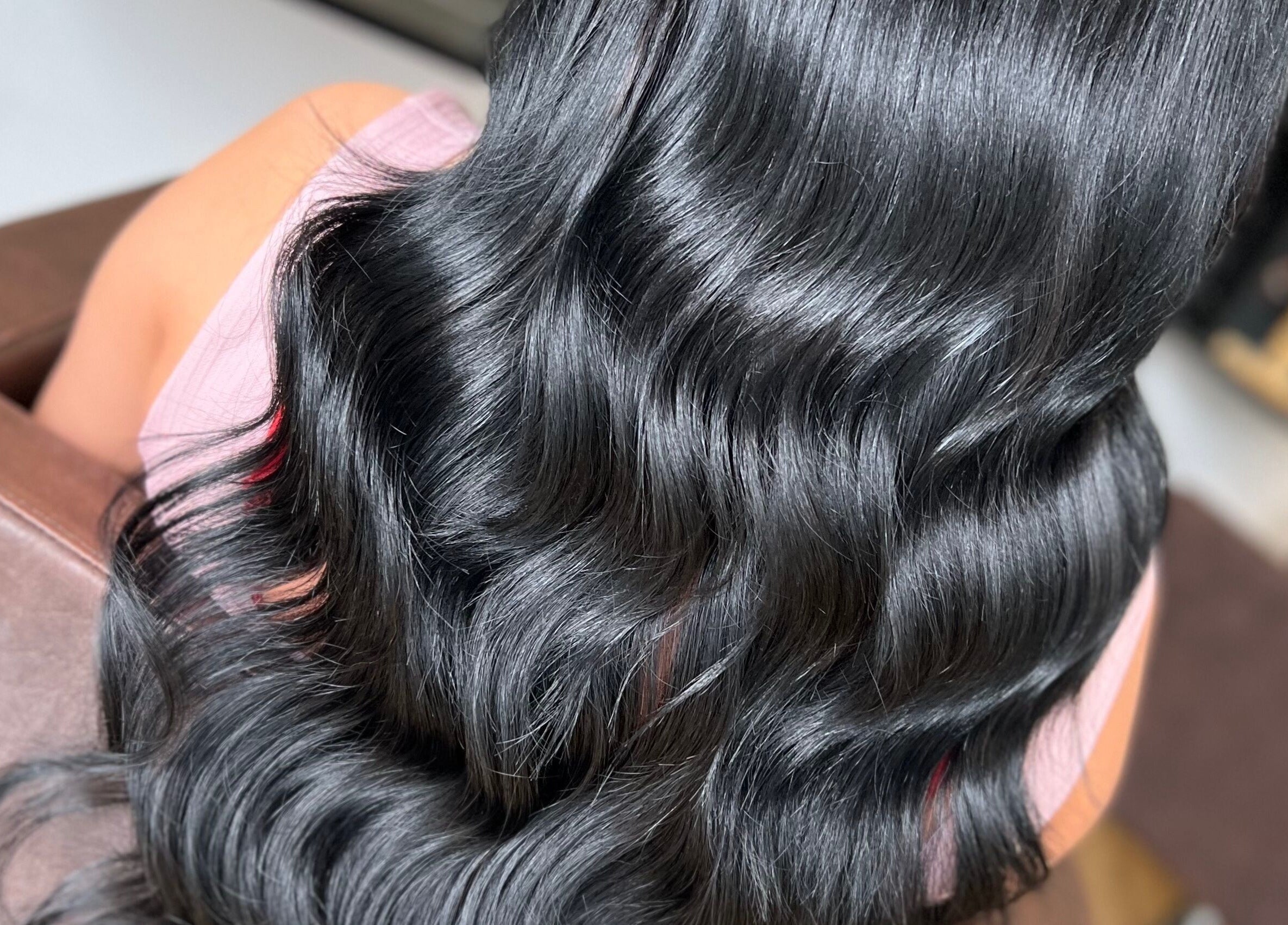 Sleek, wavy black hair styled at Danielle Farlow Hairdressing, Bolton, England, GB.