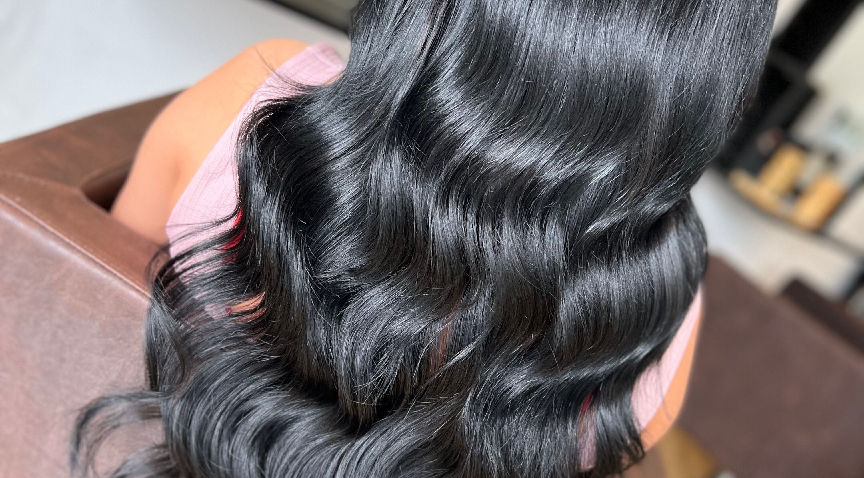 Sleek, wavy black hair styled at Danielle Farlow Hairdressing, Bolton, England, GB.