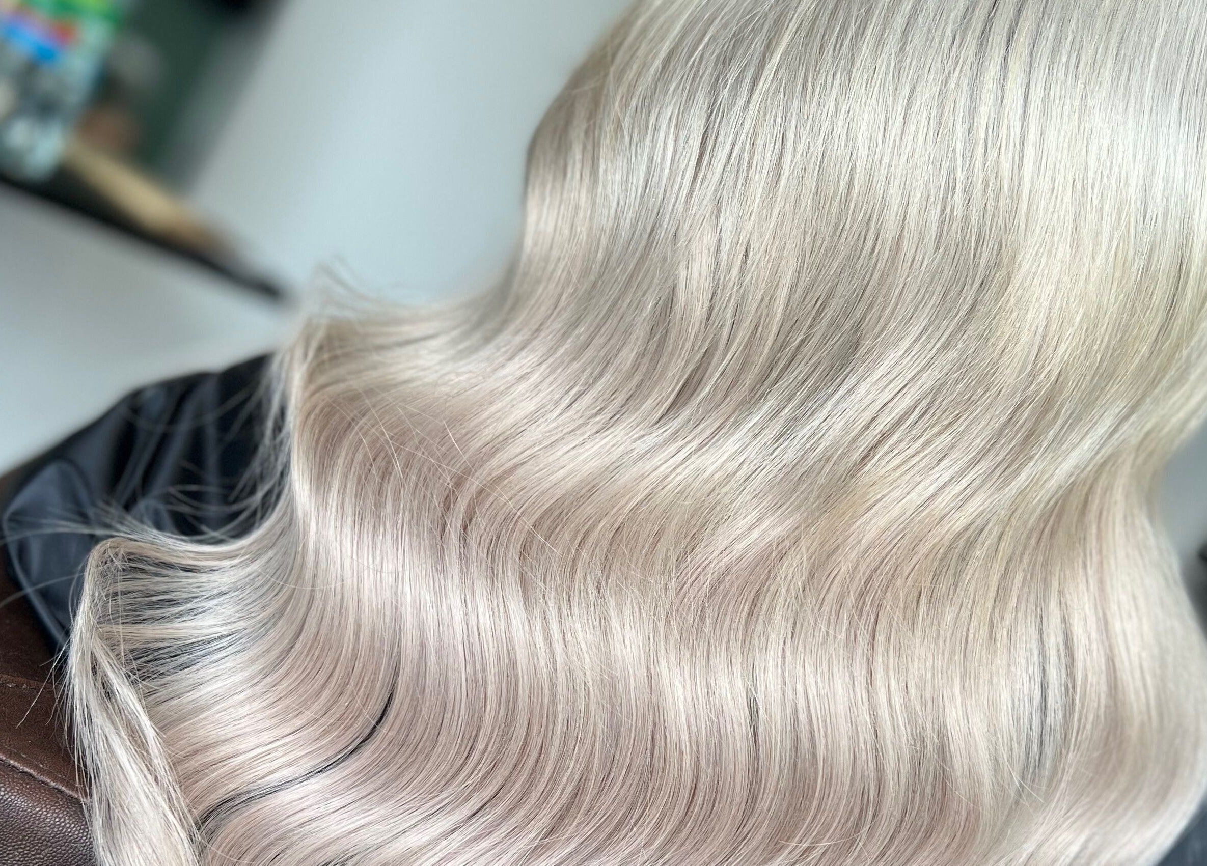 Silky blonde hair styled in waves at Danielle Farlow Hairdressing, Bolton, England, GB.