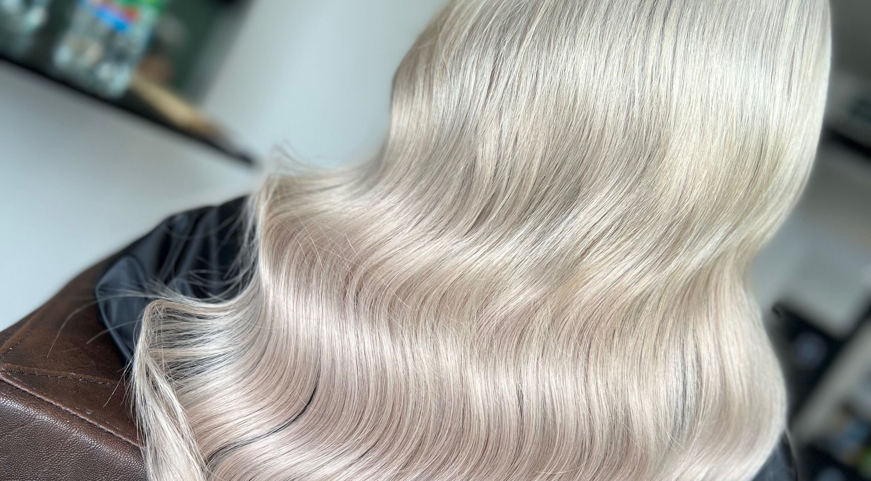 Silky blonde hair styled in waves at Danielle Farlow Hairdressing, Bolton, England, GB.