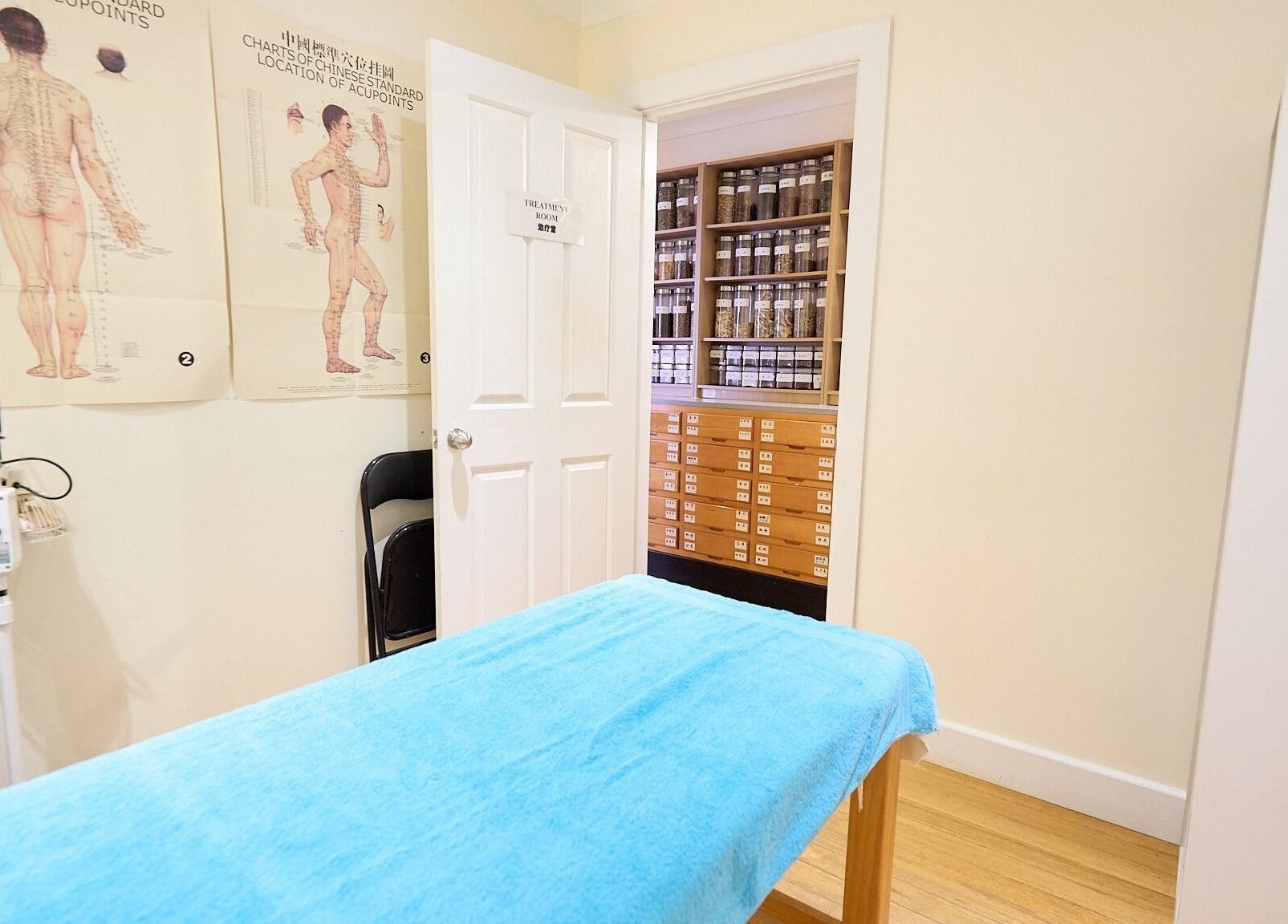 Calm treatment room at Crows Nest Acupuncture & Herbal Centre, Crows Nest, New South Wales, AU with detailed charts.