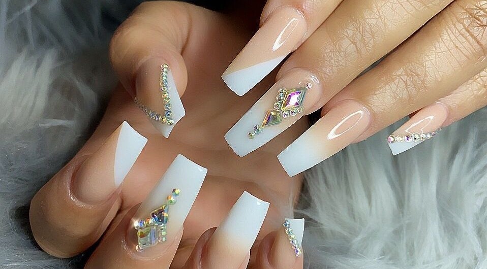 Elegant nail art with crystals at MiLinda519, Savannah, Georgia, US, showcasing intricate designs.