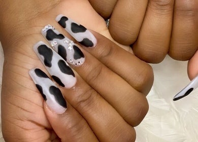Fashionable cow-print nails at MiLinda519 in Savannah, Georgia, US, showcasing bold creativity and elegance.