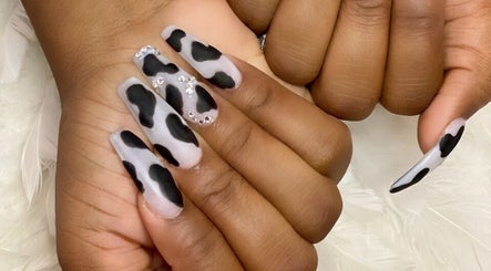 Fashionable cow-print nails at MiLinda519 in Savannah, Georgia, US, showcasing bold creativity and elegance.
