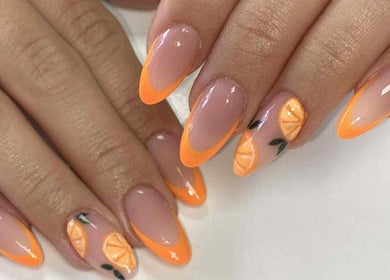 Orange-tipped nails with citrus art at Cassidy's Beauty Salon, Poole, England, GB.