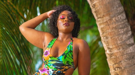 Woman in vibrant swimwear at Niva Creations, Saint Michael, enjoying a lush tropical backdrop.
