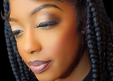 Close-up of a woman with braided hair and elegant makeup at Niva Creations, Saint Michael, BB.