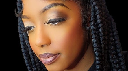 Close-up of a woman with braided hair and elegant makeup at Niva Creations, Saint Michael, BB.