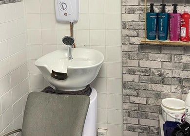 Modern hair washing station at Lashes by BW, Atherstone, England, GB with essential hair products.