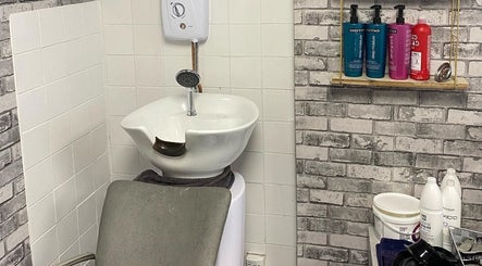 Modern hair washing station at Lashes by BW, Atherstone, England, GB with essential hair products.