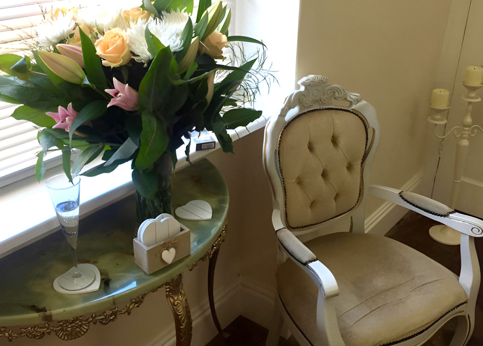 Chic floral arrangement beside plush chair at Azuri, Ripon, England, GB.