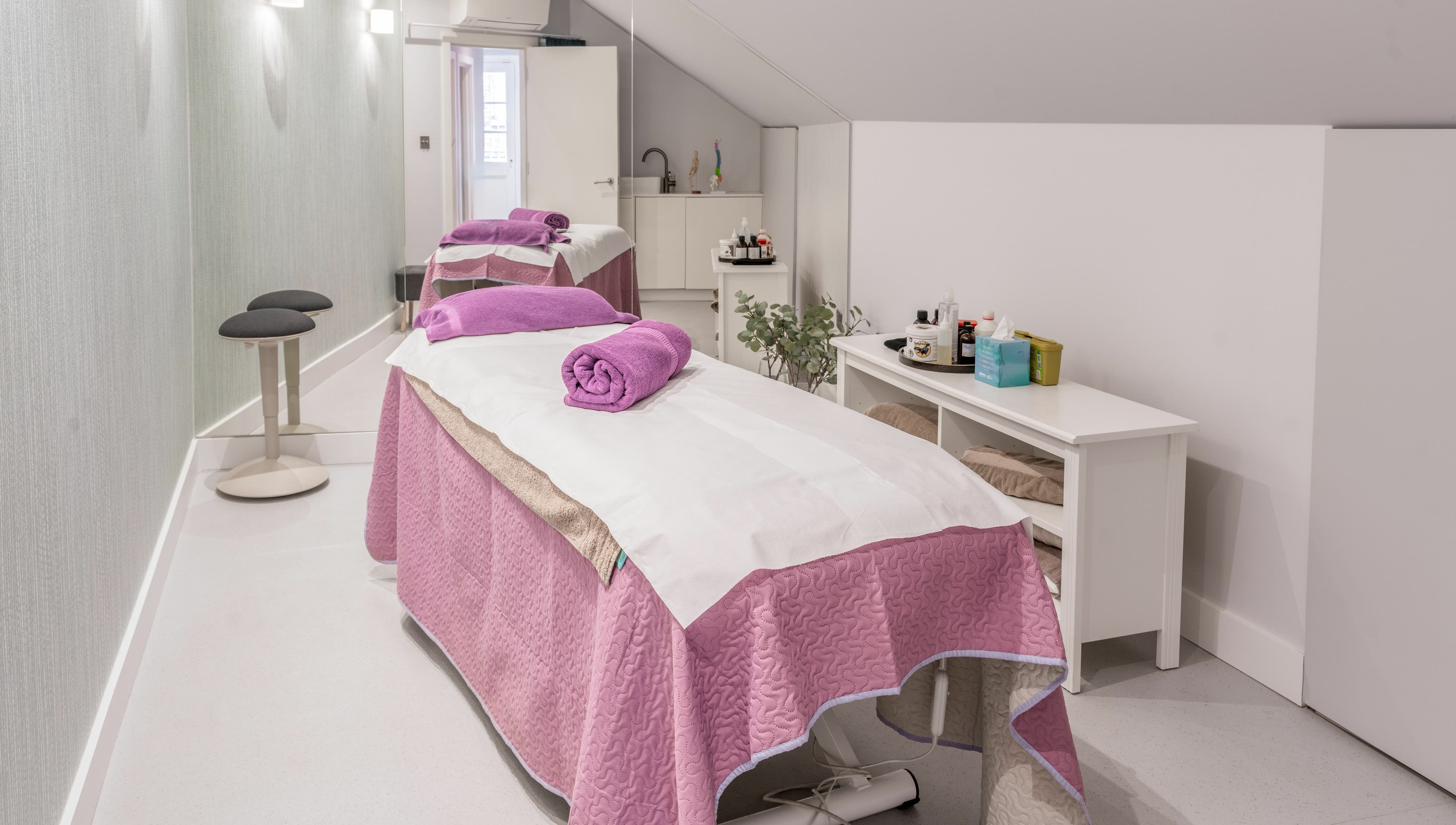 Tranquil spa room at Walking on Clouds, London, England, GB with luxurious treatment beds and soft lighting.