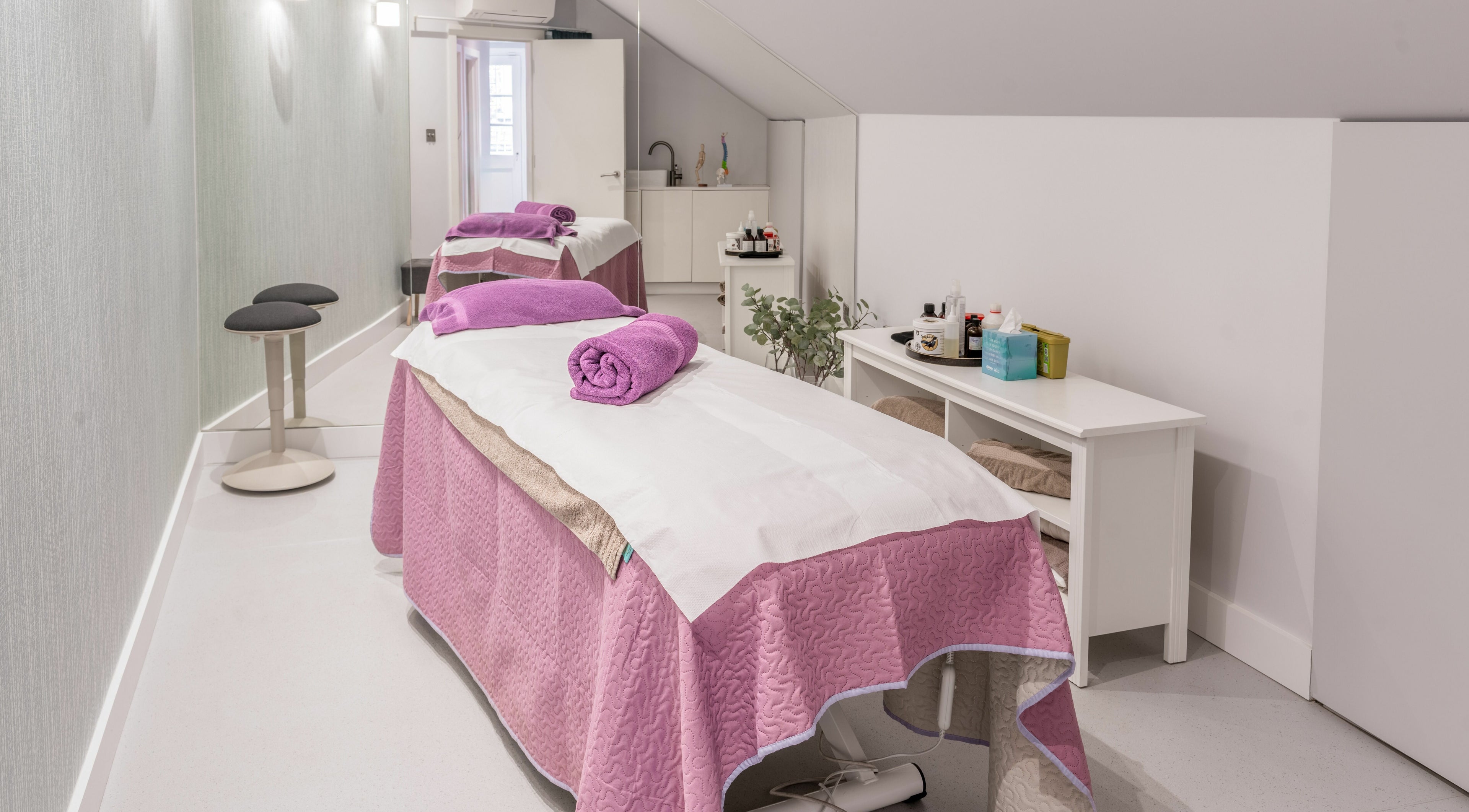 Tranquil spa room at Walking on Clouds, London, England, GB with luxurious treatment beds and soft lighting.