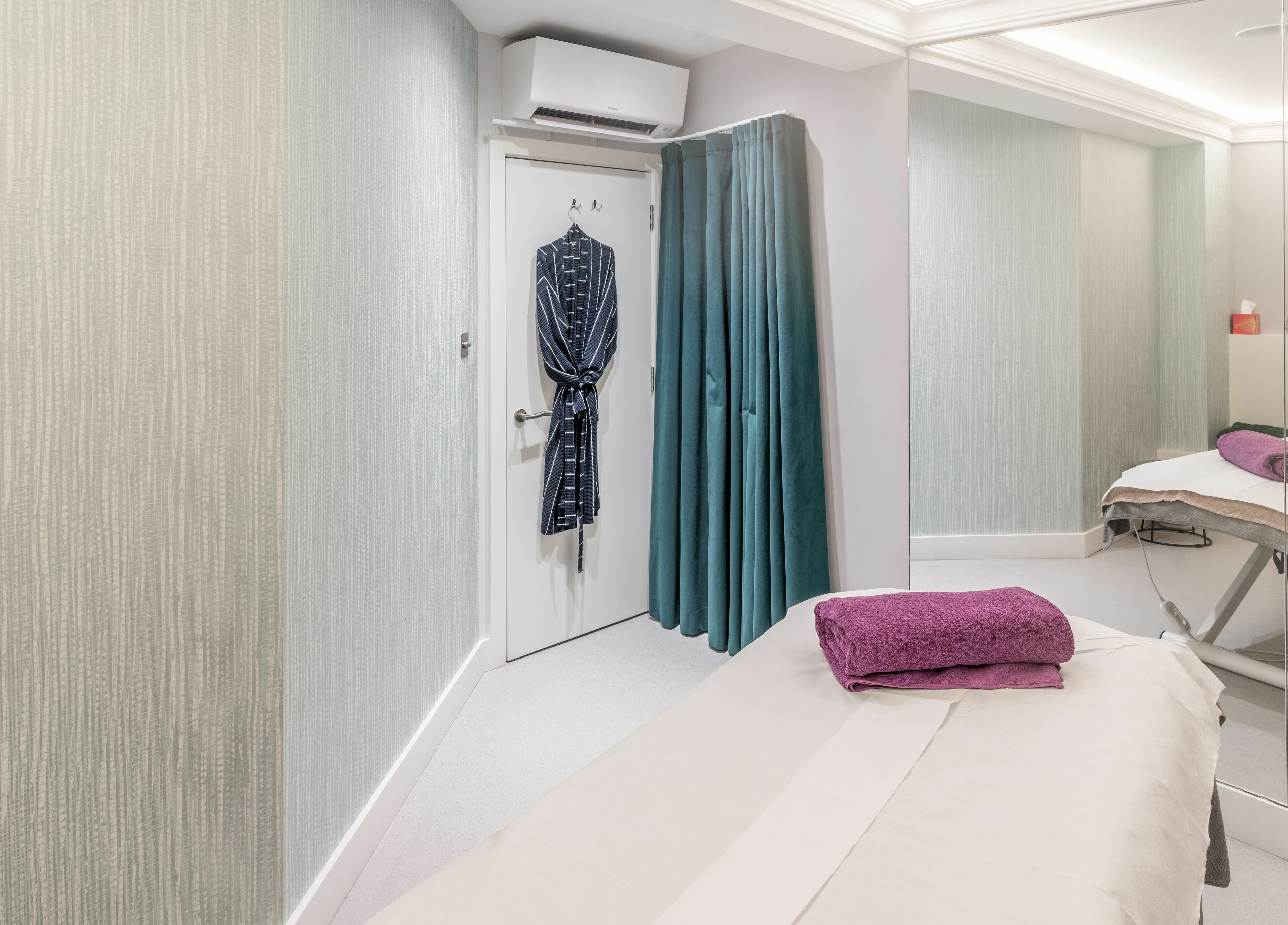 Tranquil treatment room at Walking on Clouds, London, England, GB. Includes massage table and robe.