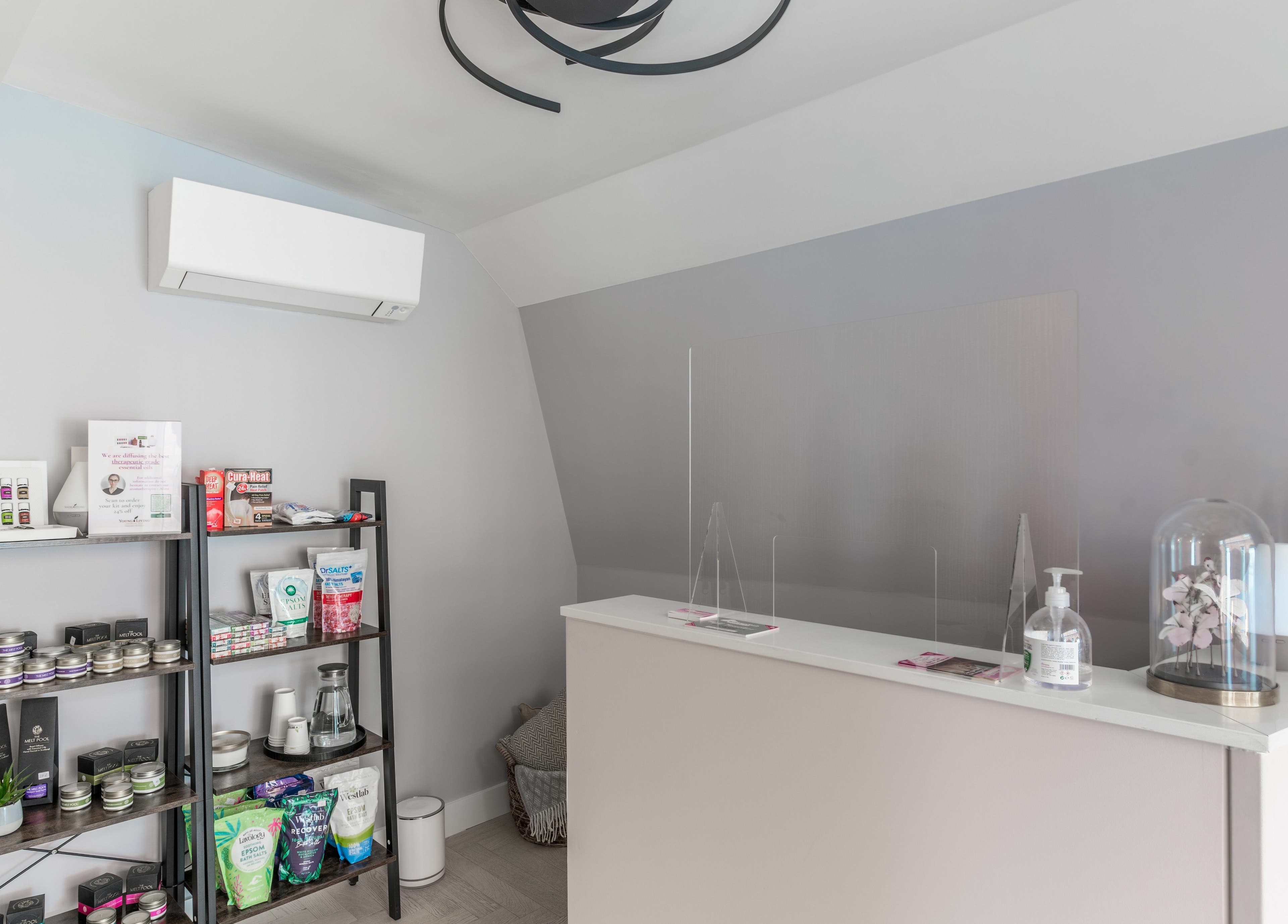 Reception area at Walking on Clouds, London, England, GB showcasing product shelves and modern decor.