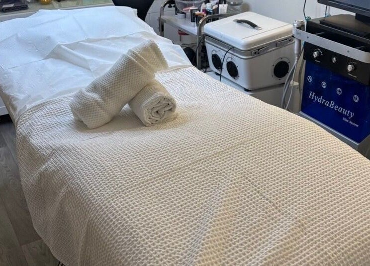 Relaxing treatment room at MBeauty, Dublin, County Dublin, IE, with a neatly prepared spa bed.