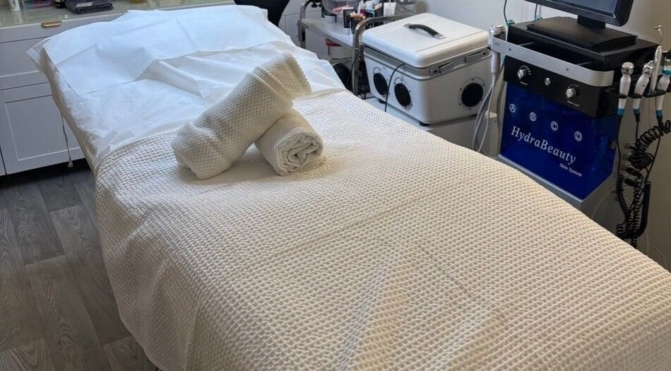 Relaxing treatment room at MBeauty, Dublin, County Dublin, IE, with a neatly prepared spa bed.