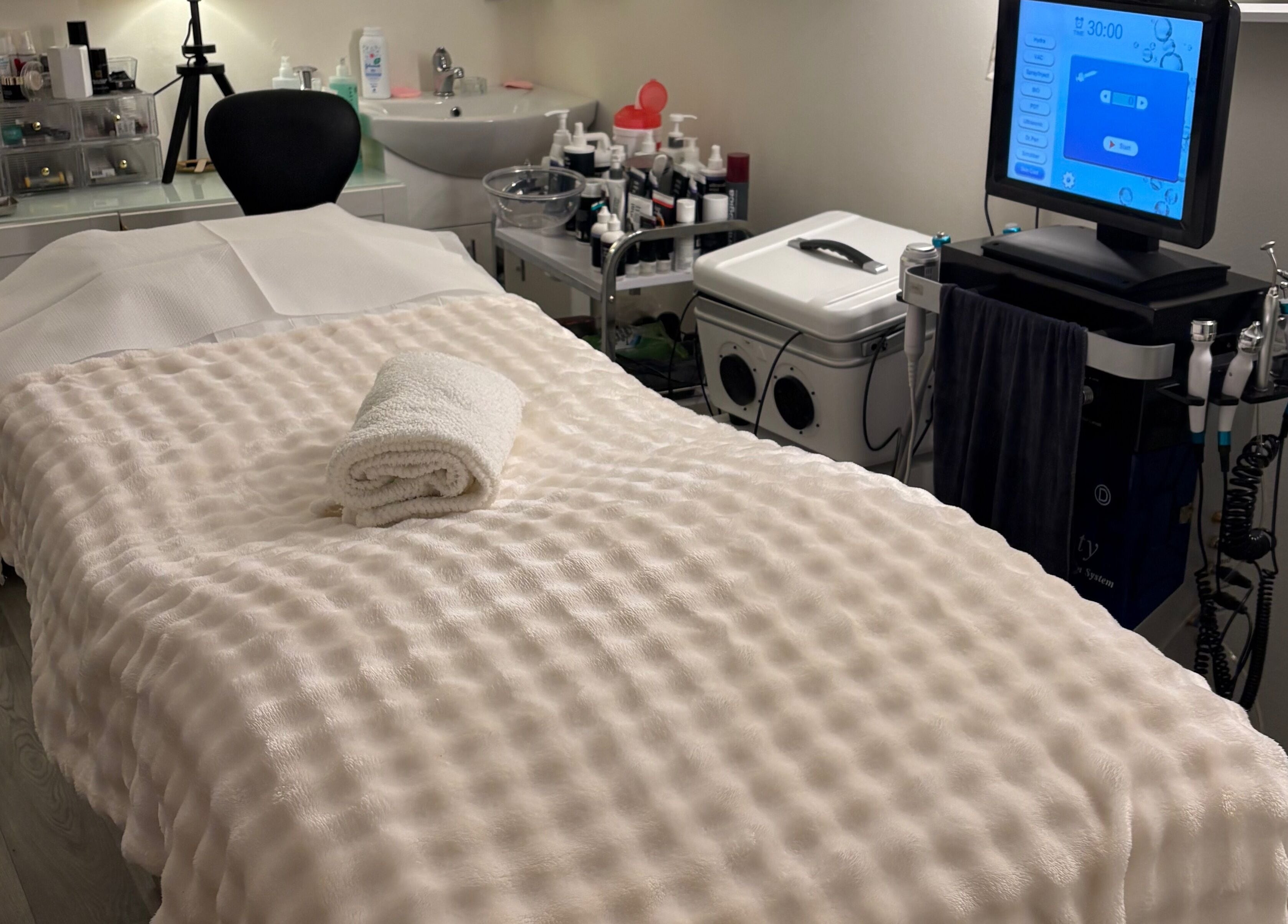 A tranquil treatment room at MBeauty, Dublin, County Dublin, IE, featuring a cozy treatment bed and equipment.