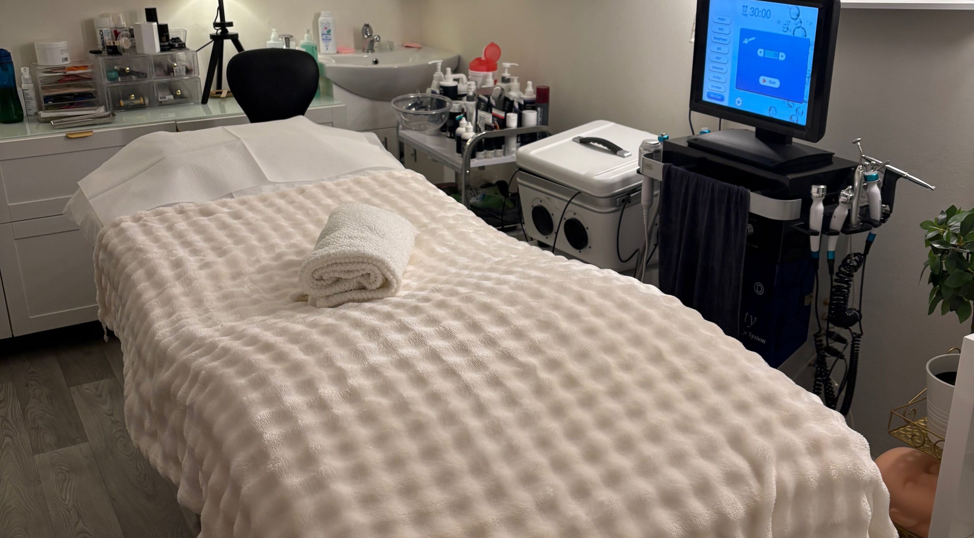 A tranquil treatment room at MBeauty, Dublin, County Dublin, IE, featuring a cozy treatment bed and equipment.