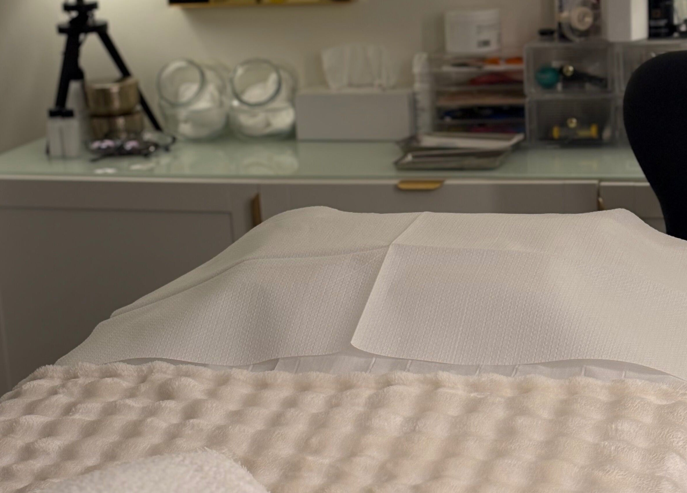 Cozy treatment room at MBeauty, Dublin, County Dublin, IE with a plush bed setup.