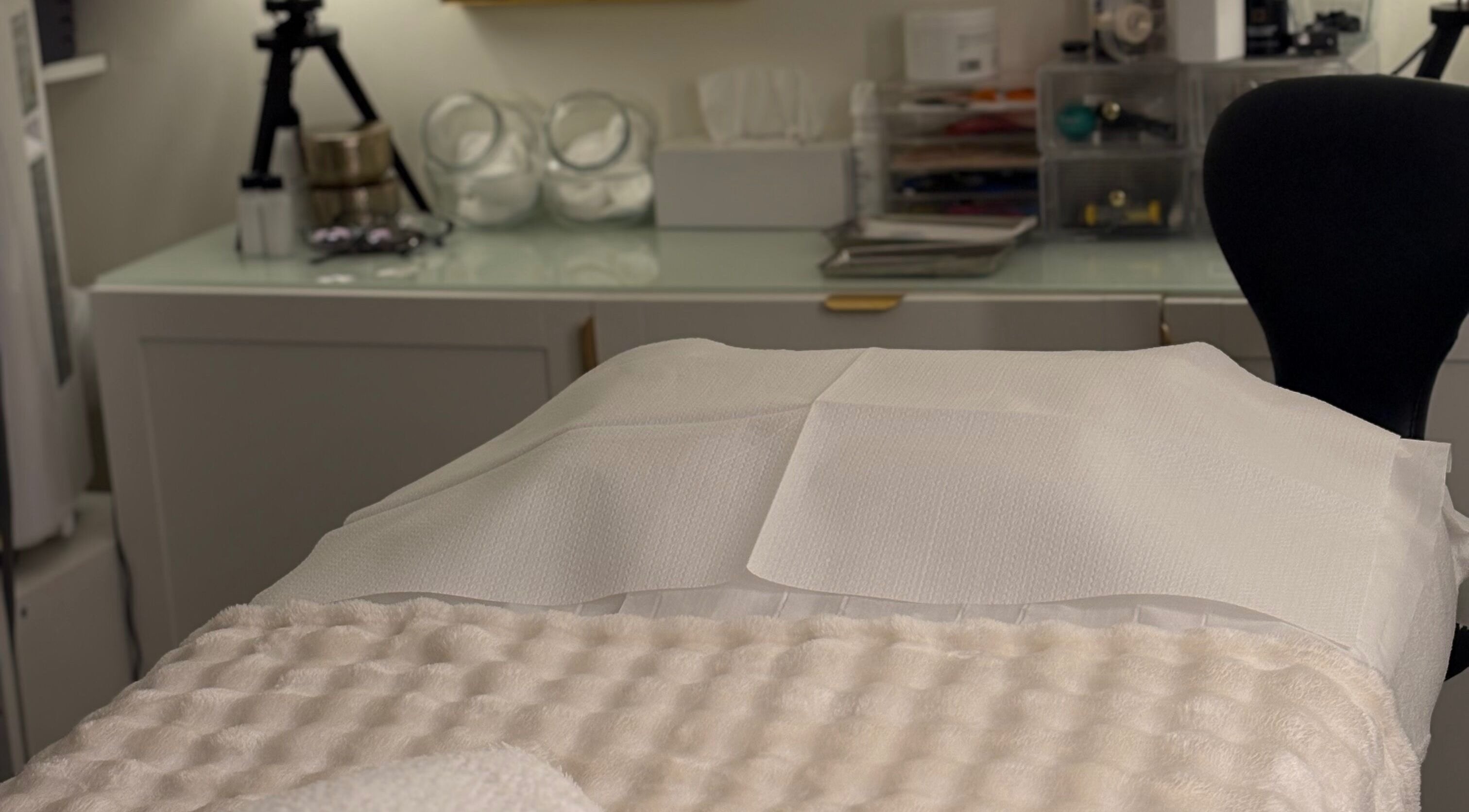 Cozy treatment room at MBeauty, Dublin, County Dublin, IE with a plush bed setup.