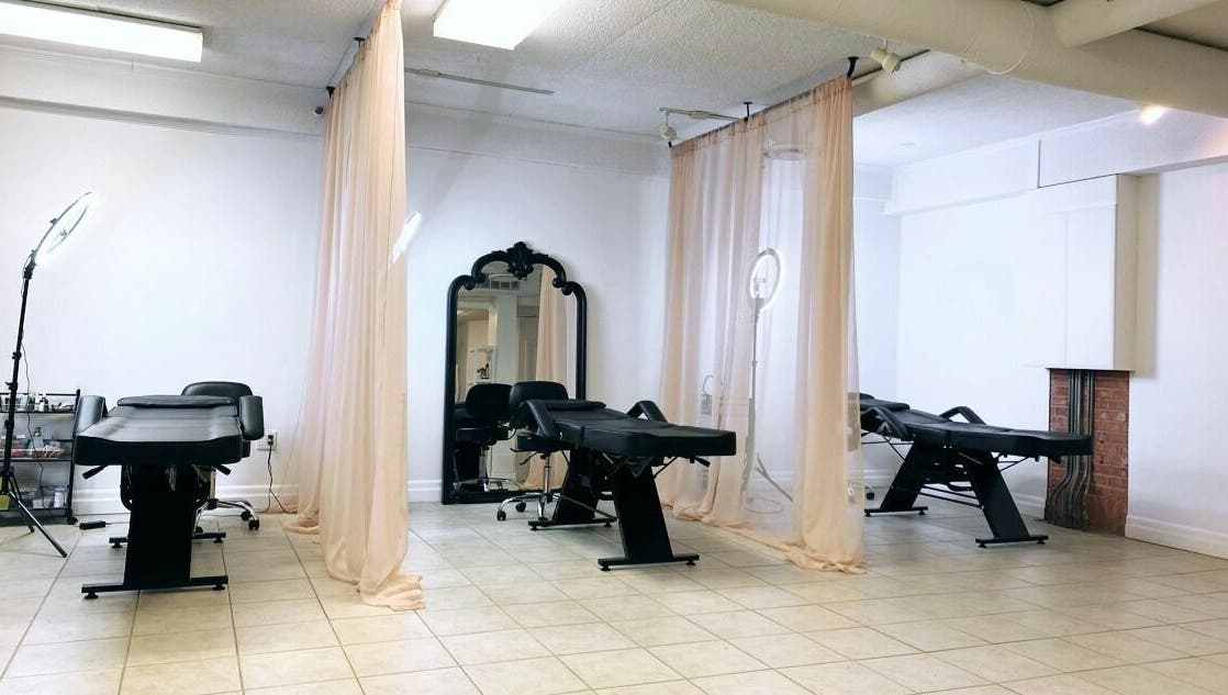 Elegant treatment area at Simah Salon with black chairs, soft drapes, and mirrors in St. Catharines, Ontario, CA.