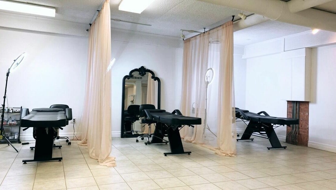Elegant treatment area at Simah Salon with black chairs, soft drapes, and mirrors in St. Catharines, Ontario, CA.
