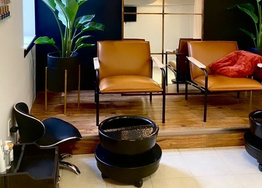 Chic salon seating at Simah Salon, St. Catharines, Ontario, CA, featuring modern chairs and lush plants.