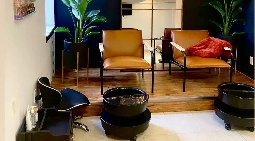 Chic salon seating at Simah Salon, St. Catharines, Ontario, CA, featuring modern chairs and lush plants.