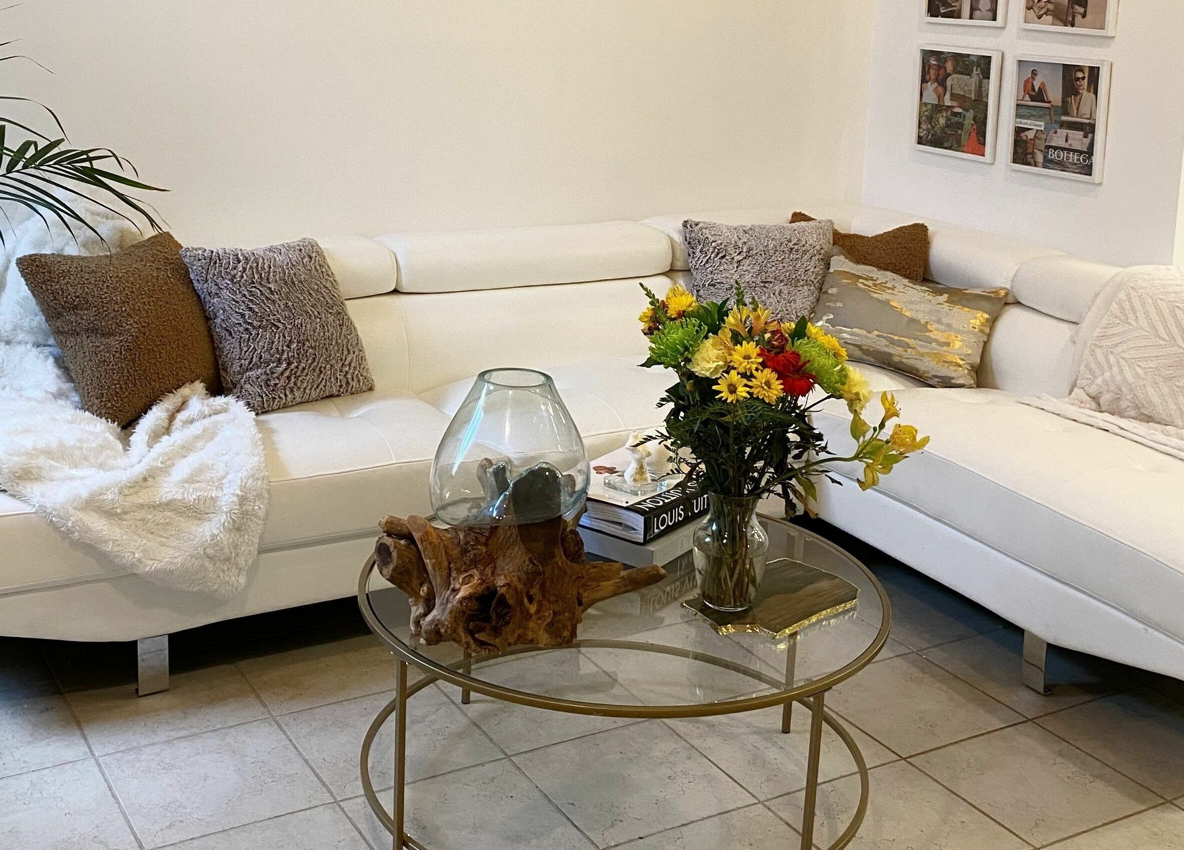 Inviting lounge at Simah Salon, St. Catharines, Ontario, CA with plush sofa and fresh flowers.