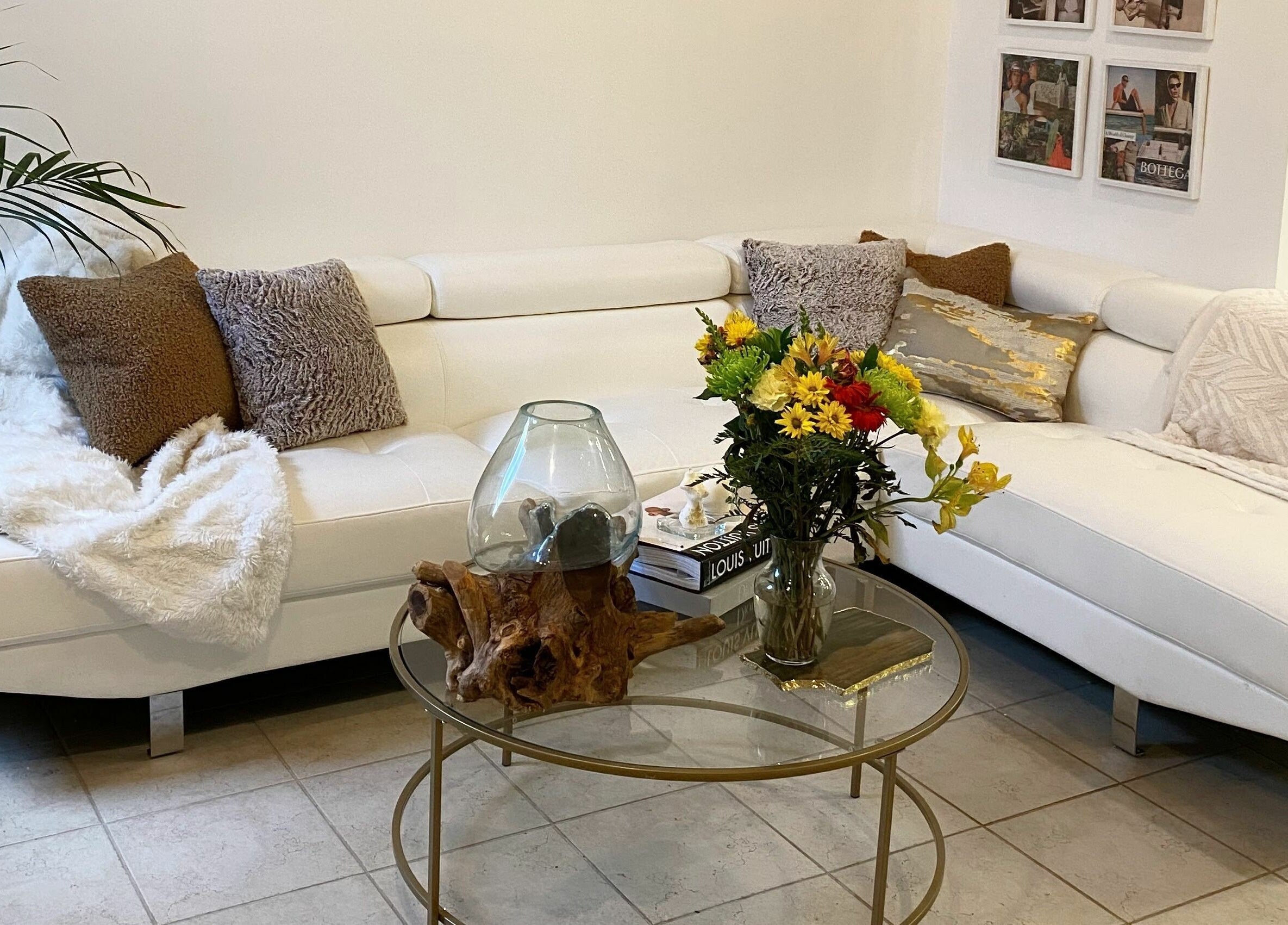 Inviting lounge at Simah Salon, St. Catharines, Ontario, CA with plush sofa and fresh flowers.