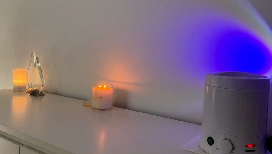 Ekera beauty in Loganlea, Queensland, AU features a calming setup with candles and aromatherapy devices.