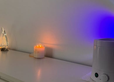 Ekera beauty in Loganlea, Queensland, AU features a calming setup with candles and aromatherapy devices.