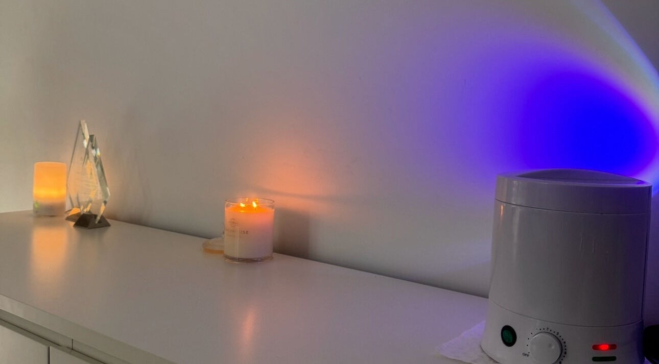 Ekera beauty in Loganlea, Queensland, AU features a calming setup with candles and aromatherapy devices.