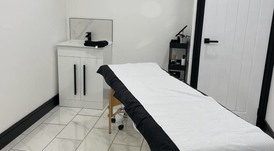 Spacious treatment room at Clash Beauty Lounge, Falkirk, Scotland, GB, featuring a bed and modern decor.