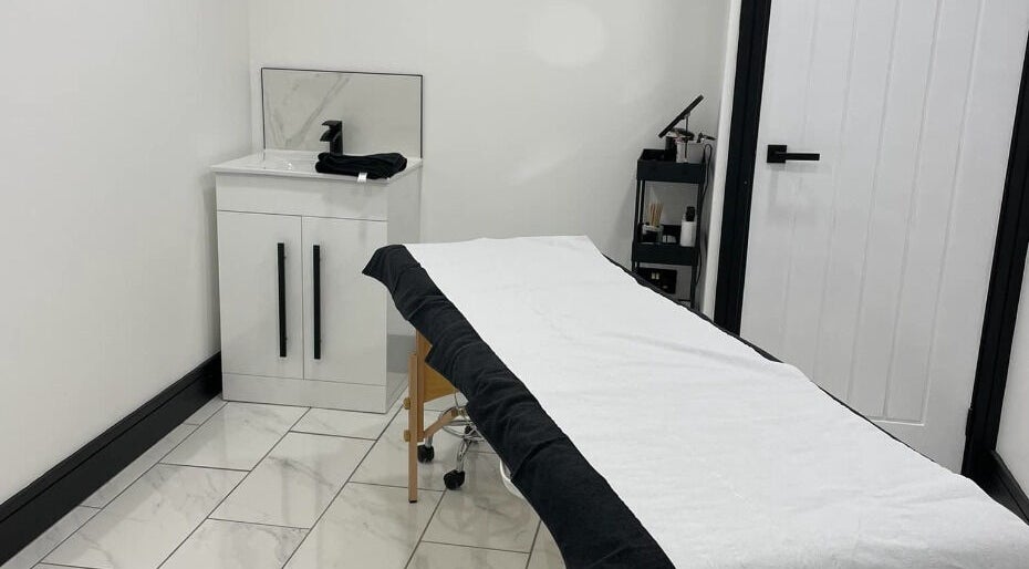 Spacious treatment room at Clash Beauty Lounge, Falkirk, Scotland, GB, featuring a bed and modern decor.