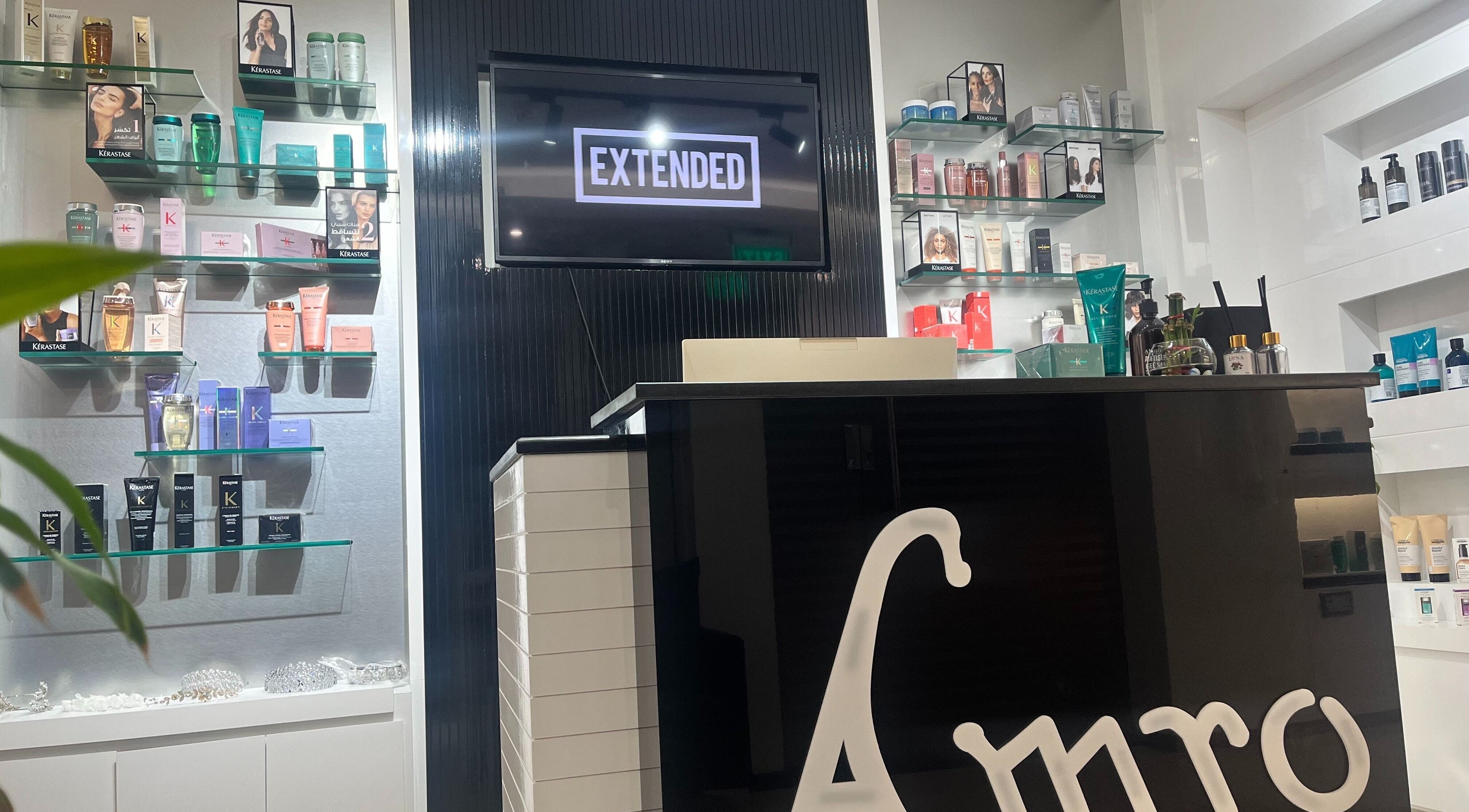 Interior of Amro Ladies Salon - Chedi Branch in Muscat showcasing luxury hair products on stylish shelves.