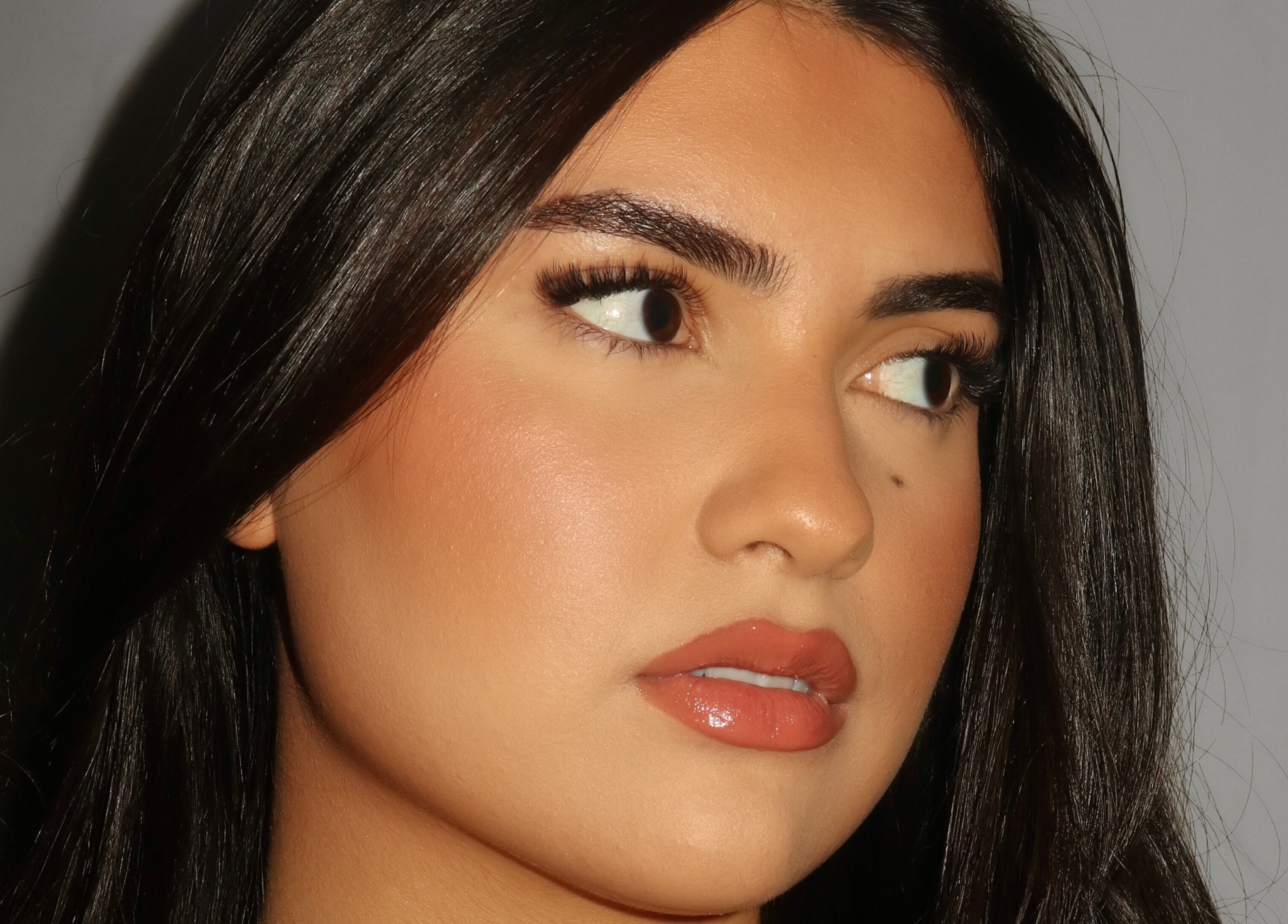 Close-up of a woman's face showcasing a flawless makeup look at Winksbyelise, Toronto, Ontario, CA.