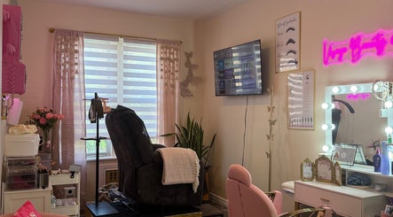 Elegant beauty room at Visage Beauty Spot in New York with plush chair and neon sign.