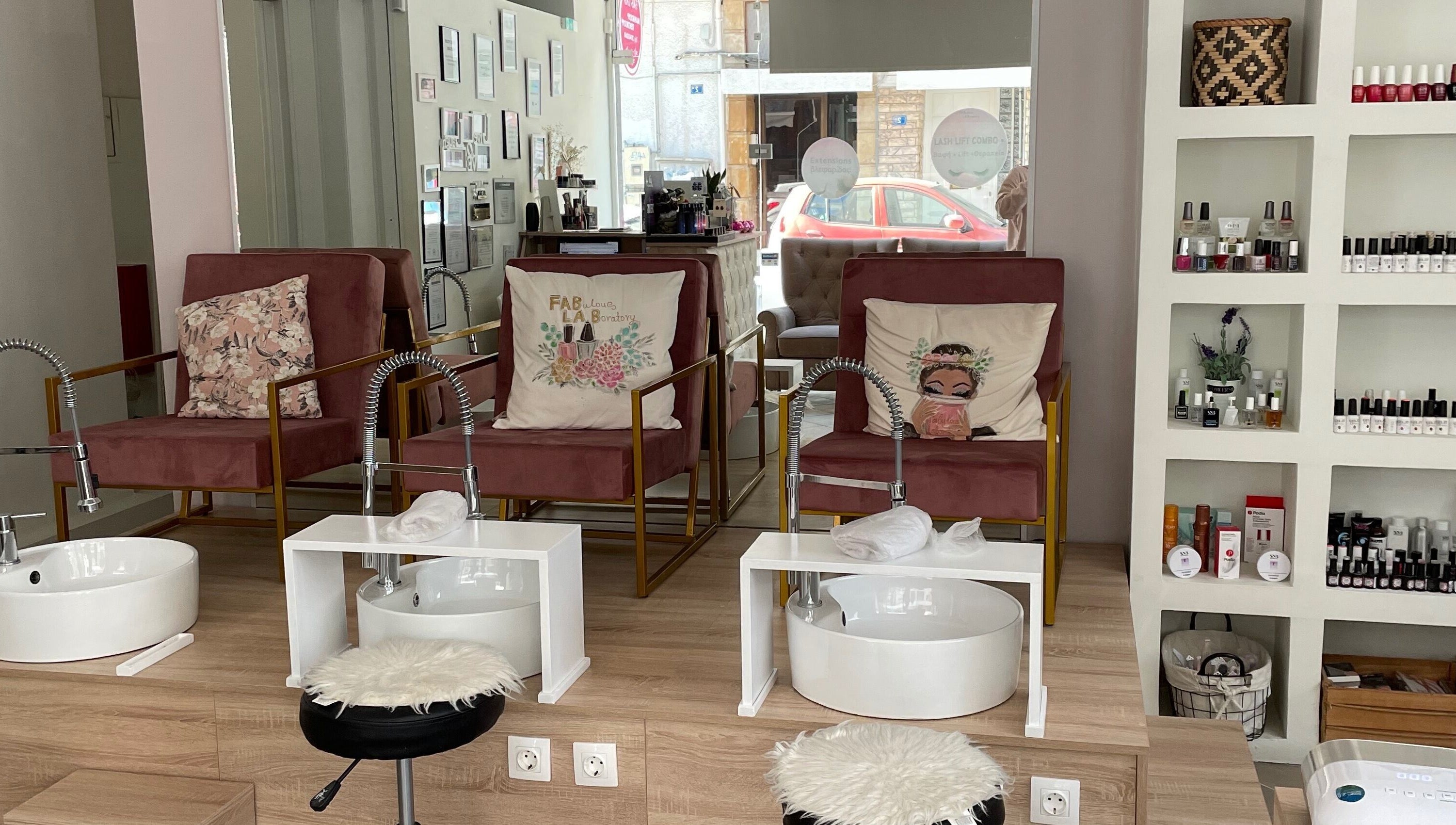 Stylish pedicure area at Fabulous Laboratory, Athina, Attici, GR with plush seating and nail polish display.