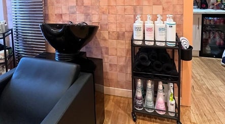 Shampoo station at Confetti Hair Club, East Kilbride, Scotland, GB, showcasing premium hair products and a sleek design.