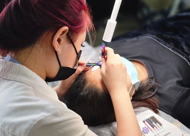 Expert applying eyelash extensions at Lashes On Fleek Singapore, Singapore, SG for a personalized beauty experience.