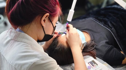 Expert applying eyelash extensions at Lashes On Fleek Singapore, Singapore, SG for a personalized beauty experience.