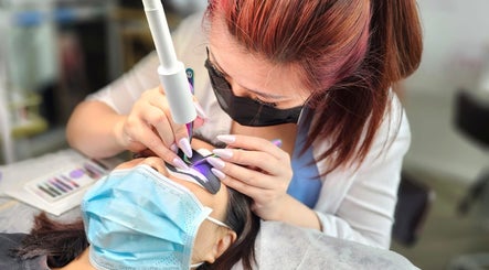 Aesthetician performing lash extensions at Lashes On Fleek Singapore, Singapore, SG.