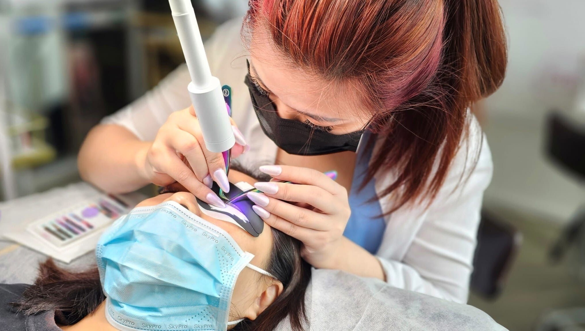 Beautician performing precise lash extension at Lashes On Fleek Singapore, Singapore, SG.