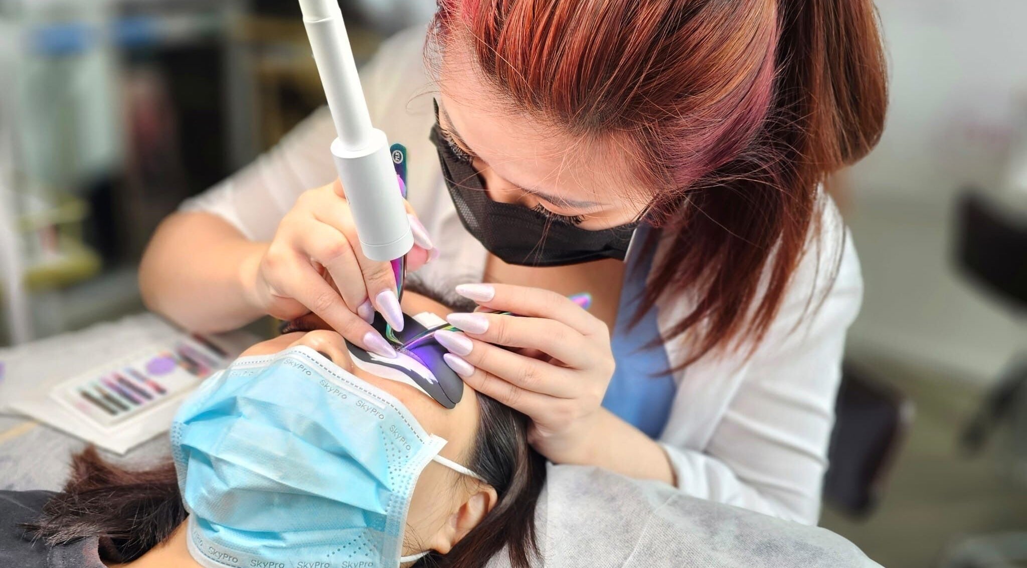 Beautician performing precise lash extension at Lashes On Fleek Singapore, Singapore, SG.